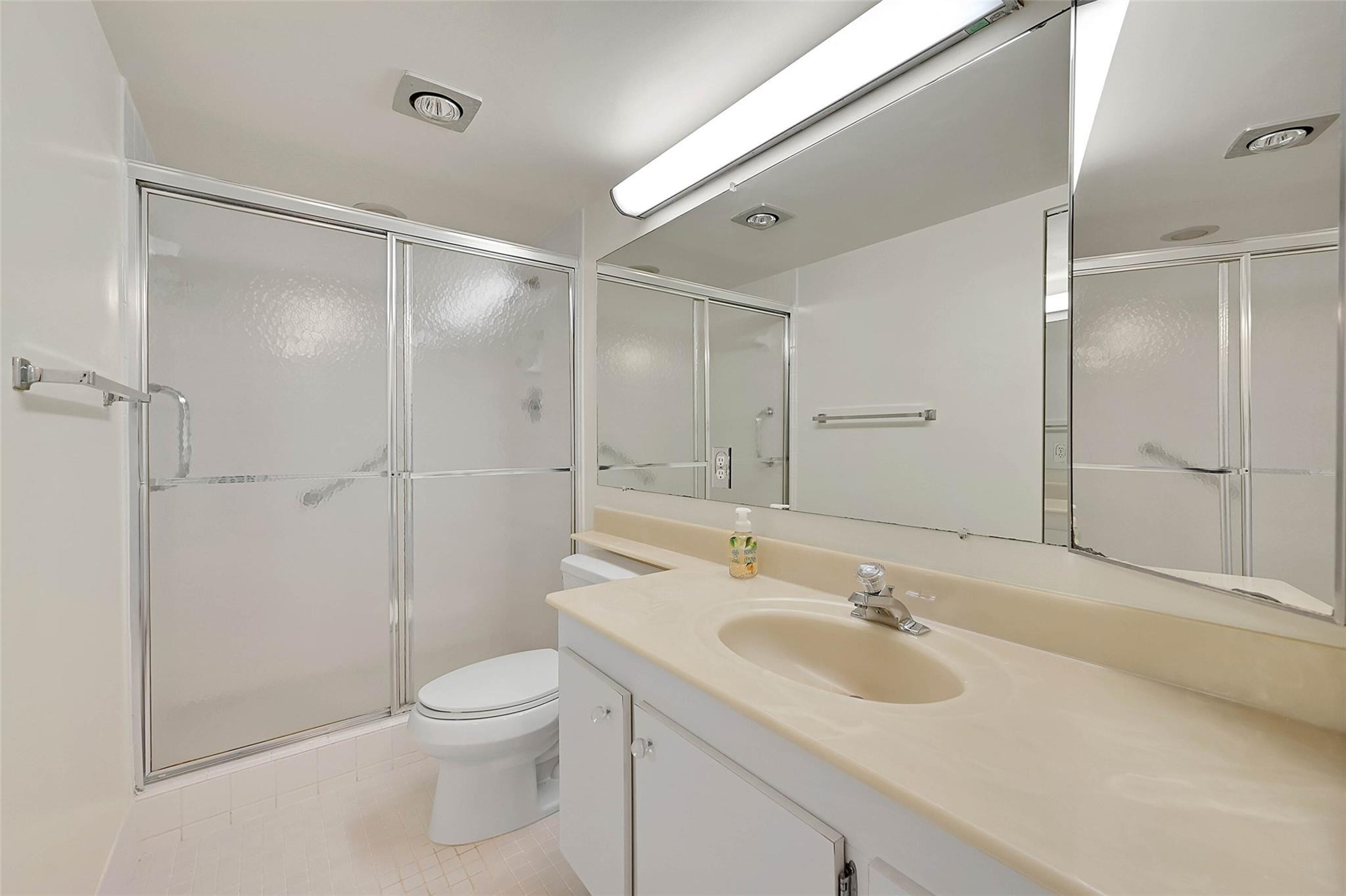 1804 Eleuthera Point, Unit E3 Coconut Creek, FL 33066 - Photo 25 of 41 a bathroom with a sink toilet and shower