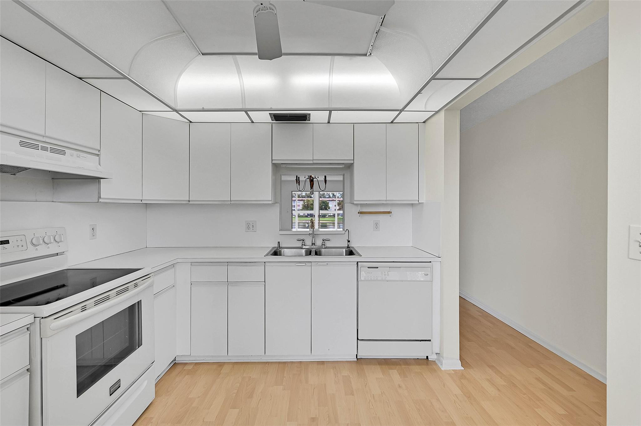 1804 Eleuthera Point, Unit E3 Coconut Creek, FL 33066 - Photo 3 of 41 a kitchen with cabinets and appliances