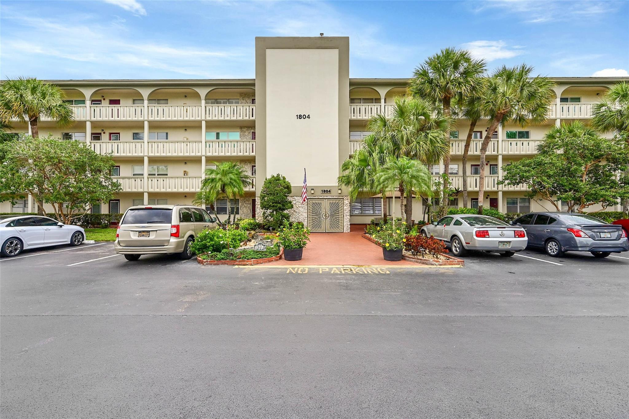 1804 Eleuthera Point, Unit E3 Coconut Creek, FL 33066 - Photo 31 of 41 a view of a cars parked in front of a building