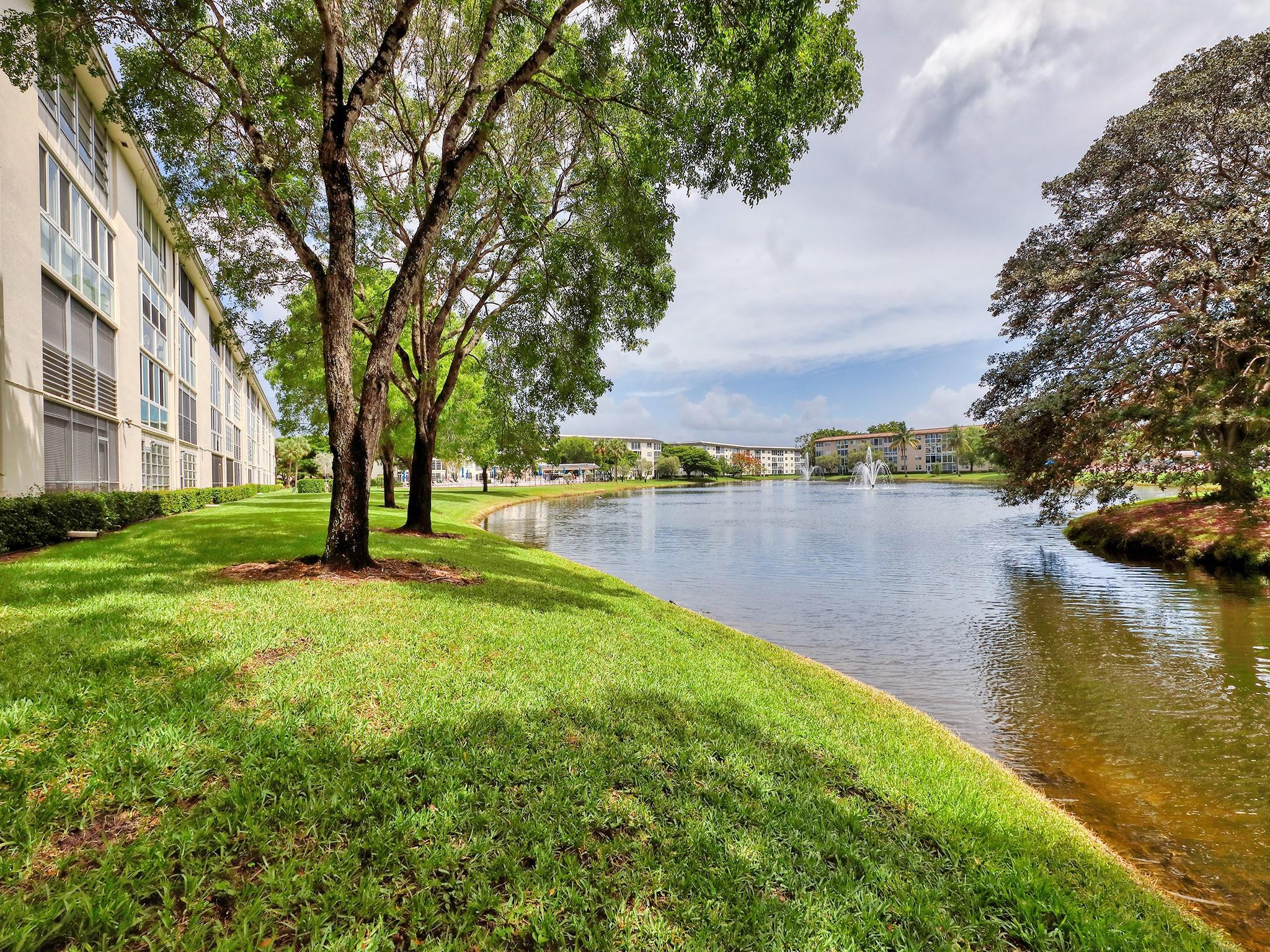 1804 Eleuthera Point, Unit E3 Coconut Creek, FL 33066 - Photo 33 of 41 a view of a lake with houses in the back