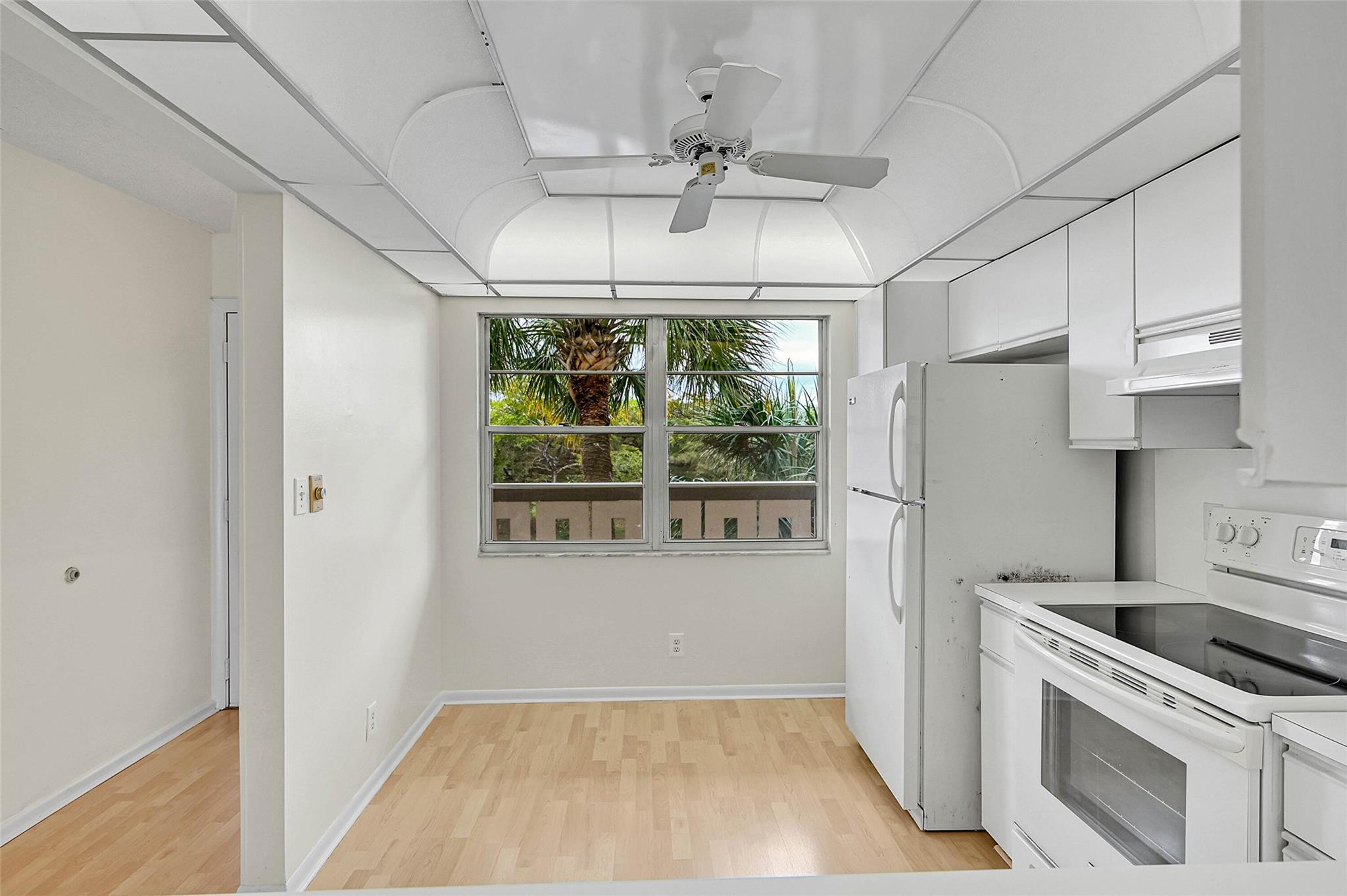 1804 Eleuthera Point, Unit E3 Coconut Creek, FL 33066 - Photo 6 of 41 a kitchen with stainless steel appliances a stove a refrigerator and a white cabinets