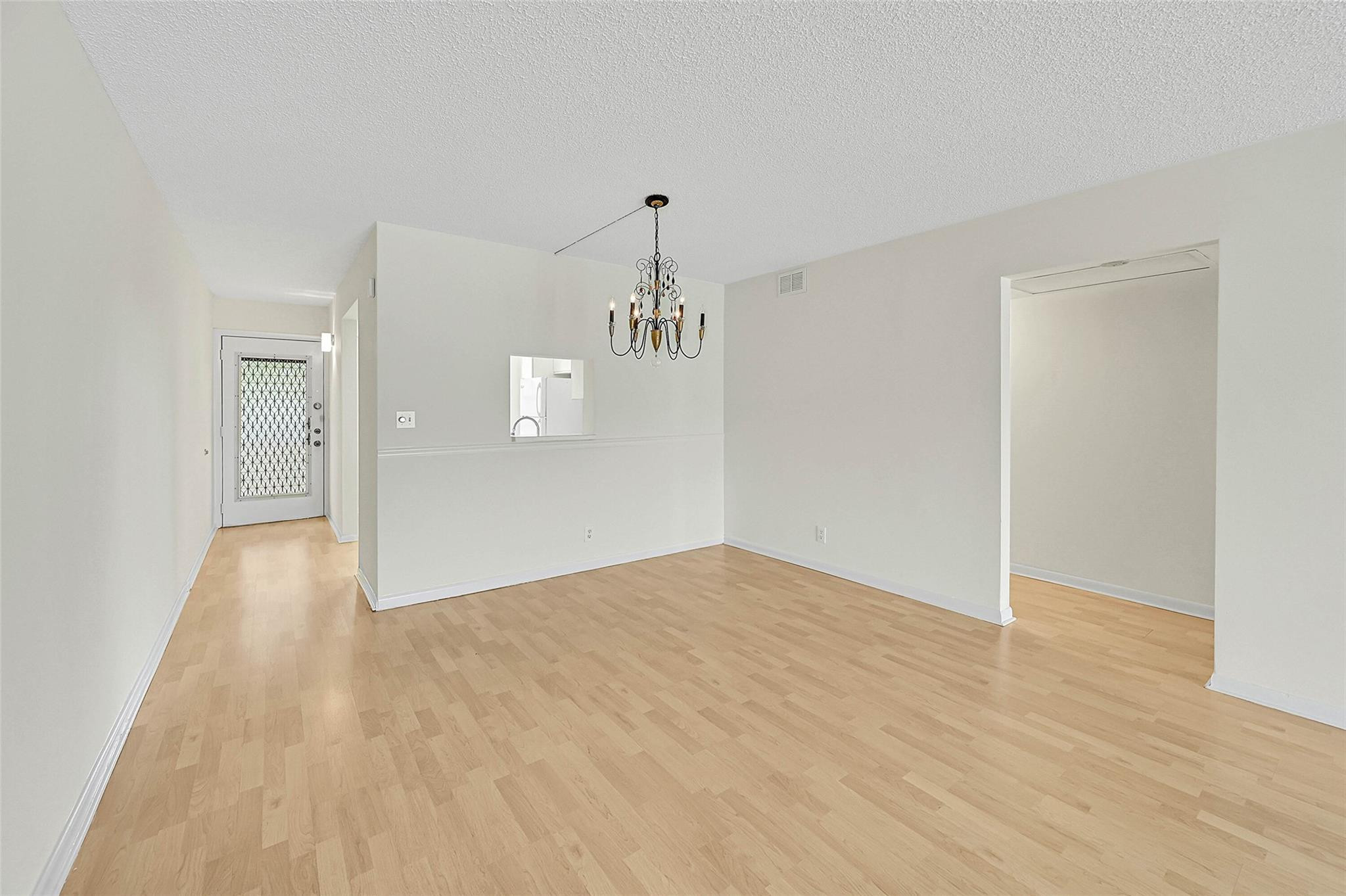 1804 Eleuthera Point, Unit E3 Coconut Creek, FL 33066 - Photo 7 of 41 a view of empty room with wooden floor