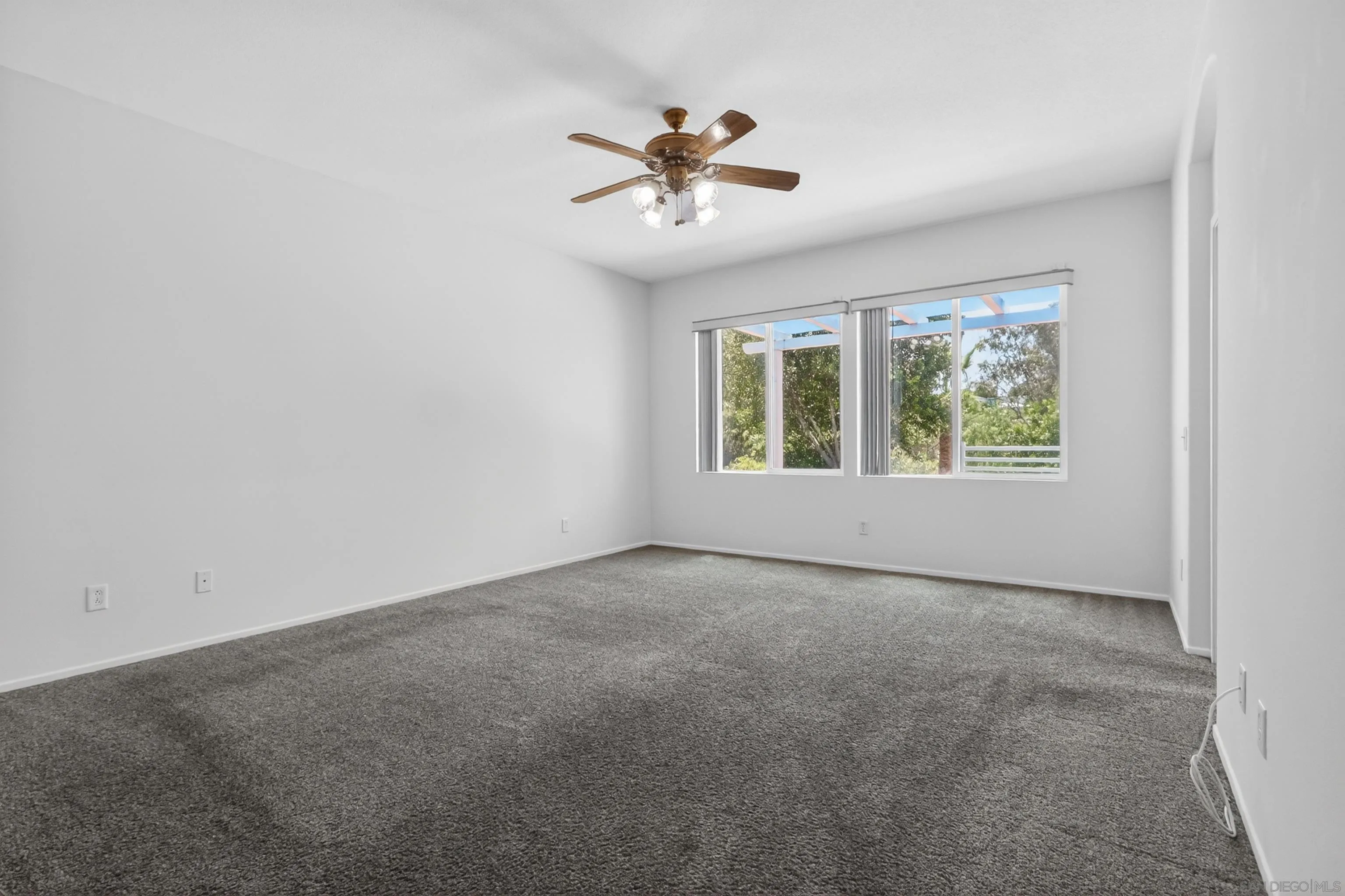 1432 Belmont Park Road Oceanside, CA 92057 - Photo 38 of 54 an empty room with a window and a ceiling fan