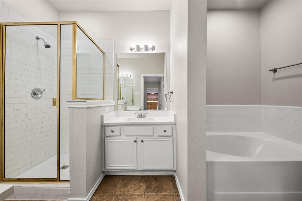 7928 Hill Country Lane Dallas, TX 75249 - Photo 11 of 19 a bathroom with a granite countertop sink a toilet and shower