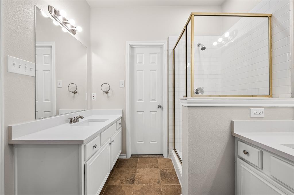 7928 Hill Country Lane Dallas, TX 75249 - Photo 12 of 19 a bathroom with a double vanity sink mirror and double