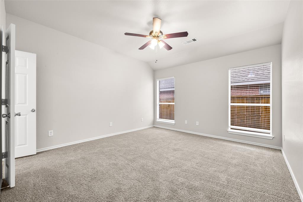 7928 Hill Country Lane Dallas, TX 75249 - Photo 10 of 19 an empty room with windows and fan