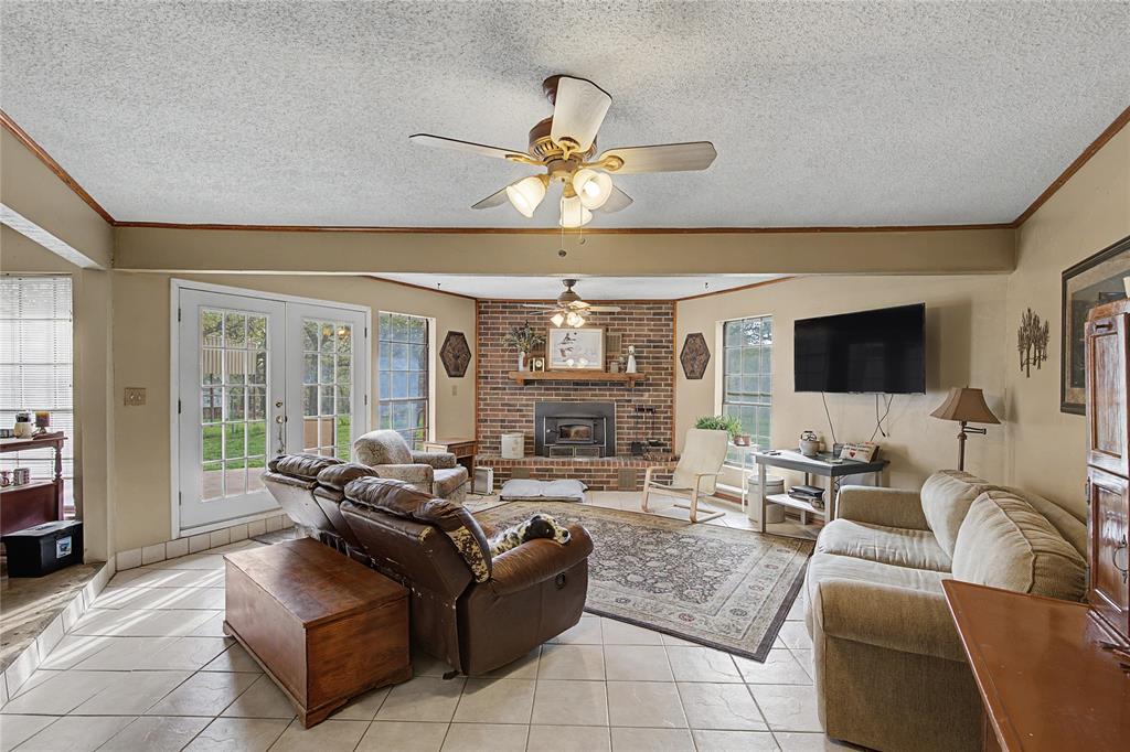 243 County Road 3851 Poolville, TX 76487 - Photo 7 of 34 a living room with furniture and a large window