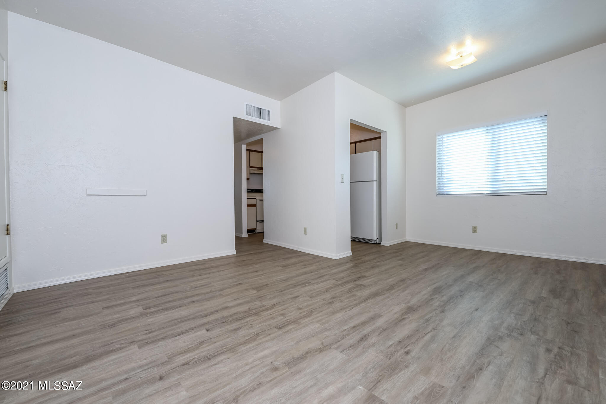 312 East 24th Street, Unit 4 Tucson, AZ 85713 - Photo 3 of 17 an empty room with wooden floor and windows