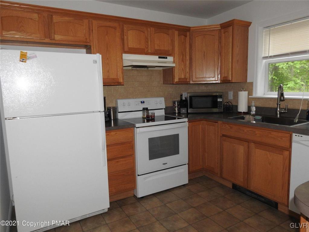 1170 Boulder Road Blakeslee, PA 18610 - Photo 12 of 46 a white refrigerator freezer sitting in a kitchen