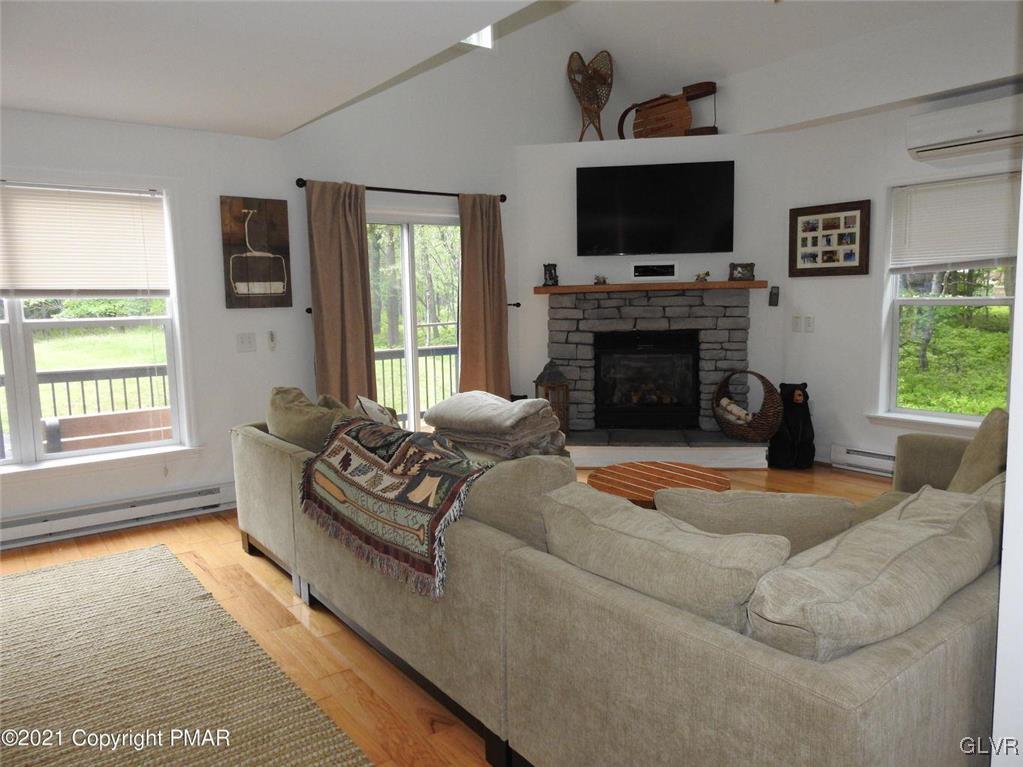 1170 Boulder Road Blakeslee, PA 18610 - Photo 20 of 46 a living room with furniture a flat screen tv and a fireplace