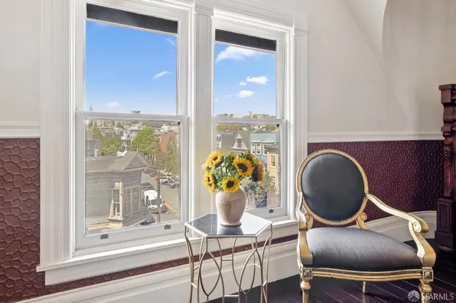 a view of a workspace with furniture window and wooden floor