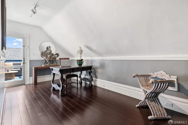 a view of a balcony with furniture and a potted plant