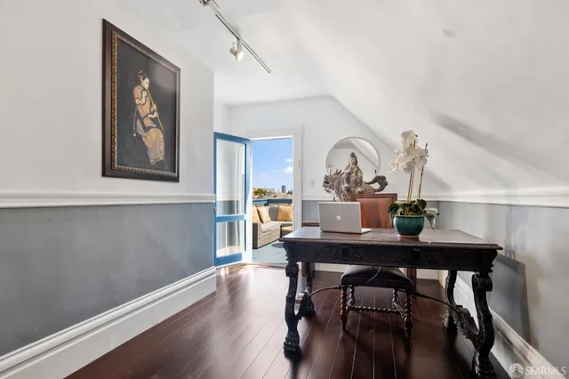 a living room with furniture a dining table and wooden floor