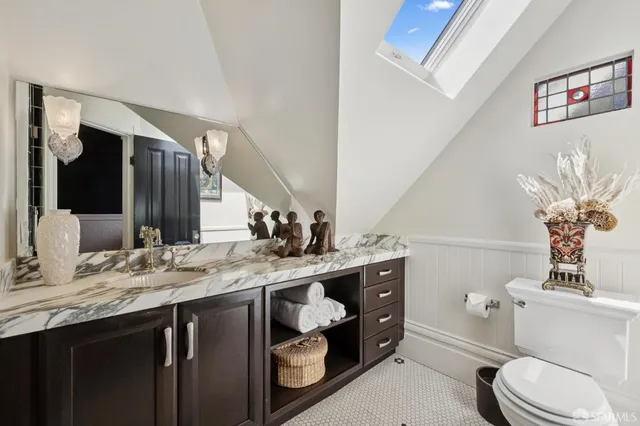 a kitchen with granite countertop a sink a stove and cabinets