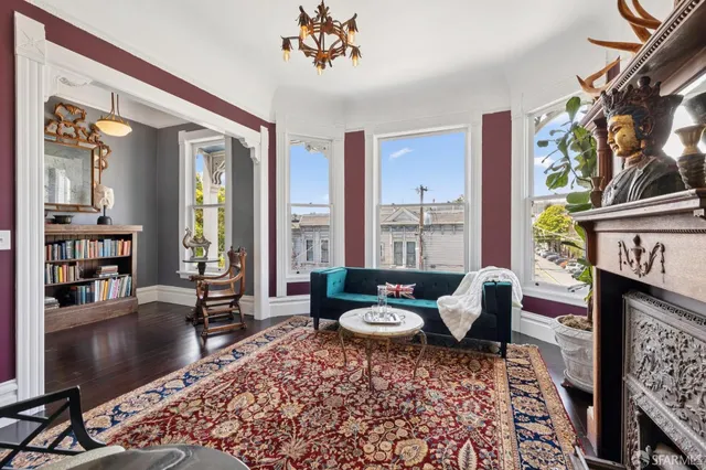 a living room with furniture a rug and a fireplace