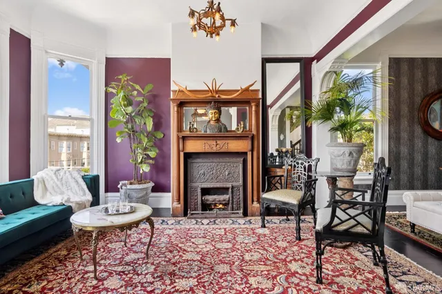 a living room with furniture a fireplace and a table