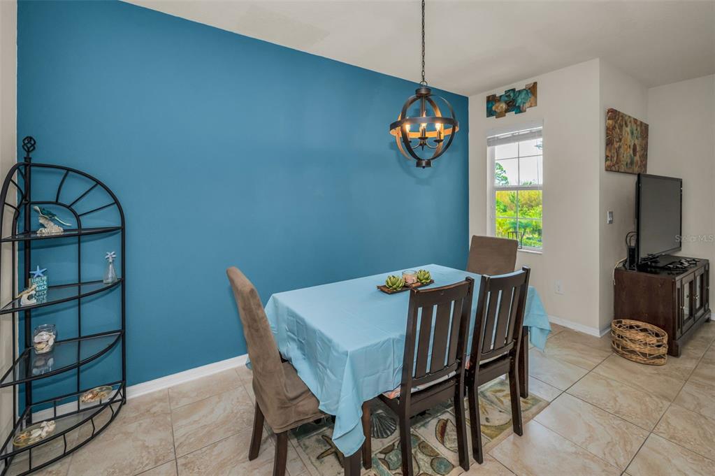 5529 White Marlin Court New Port Richey, FL 34652 - Photo 21 of 63 a view of a dining room with furniture and a chandelier