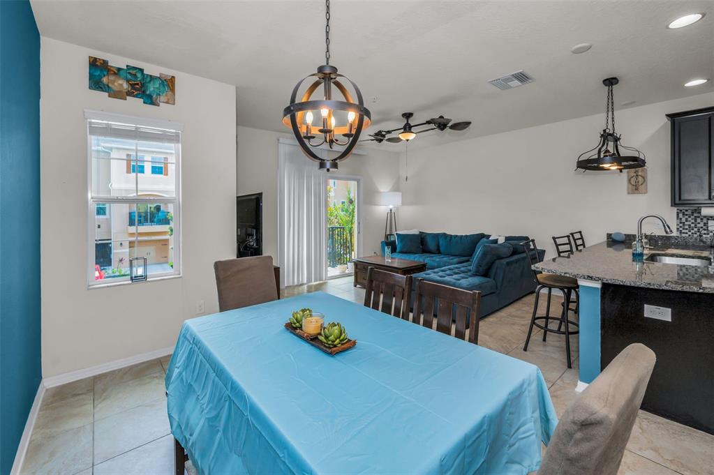 5529 White Marlin Court New Port Richey, FL 34652 - Photo 22 of 63 a view of a dining room with furniture and chandelier