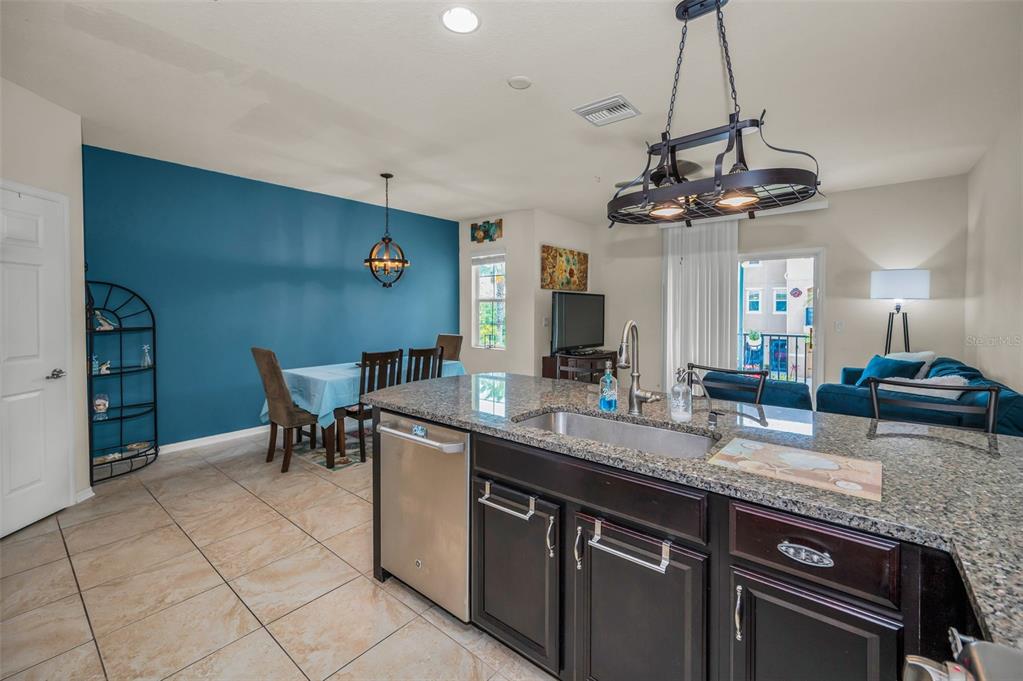 5529 White Marlin Court New Port Richey, FL 34652 - Photo 23 of 63 a kitchen with stainless steel appliances granite countertop a sink a stove and a wooden floors