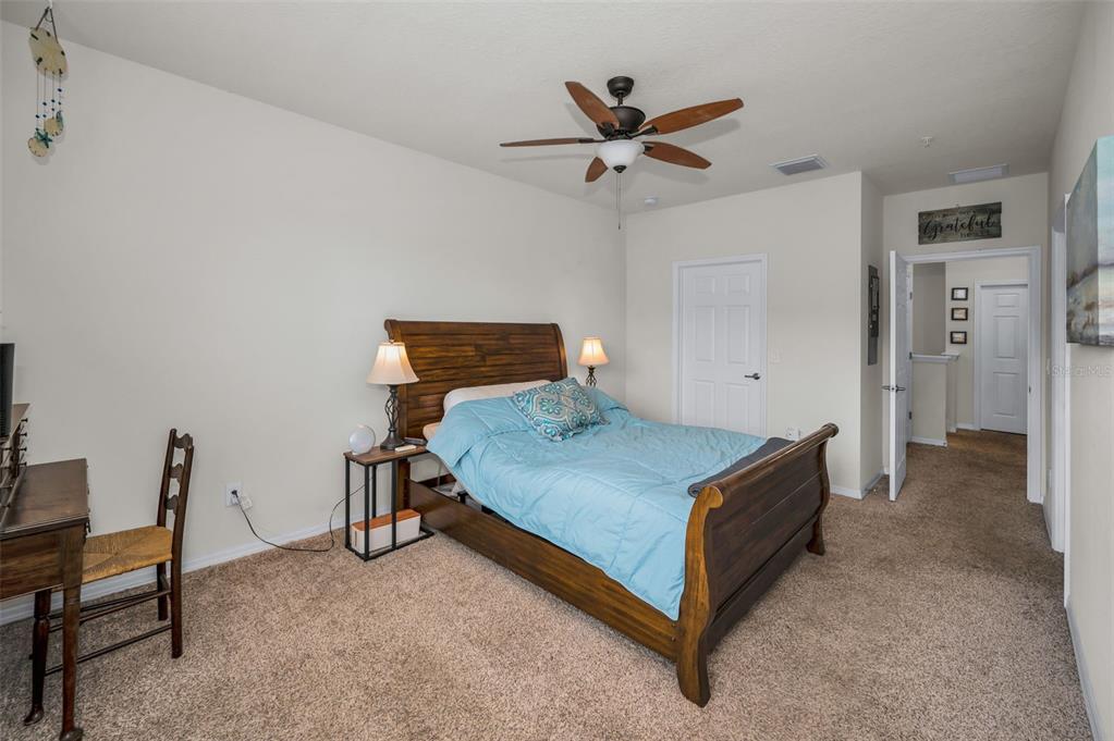 5529 White Marlin Court New Port Richey, FL 34652 - Photo 36 of 63 a bedroom with a bed and a table in it