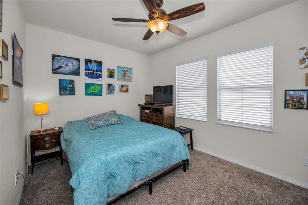 5529 White Marlin Court New Port Richey, FL 34652 - Photo 41 of 63 a bedroom with a bed and a chandelier