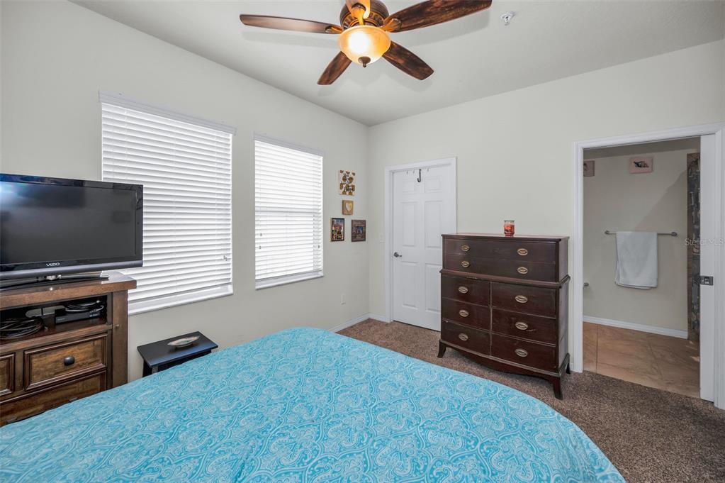 5529 White Marlin Court New Port Richey, FL 34652 - Photo 42 of 63 a bedroom with a bed and flat screen tv