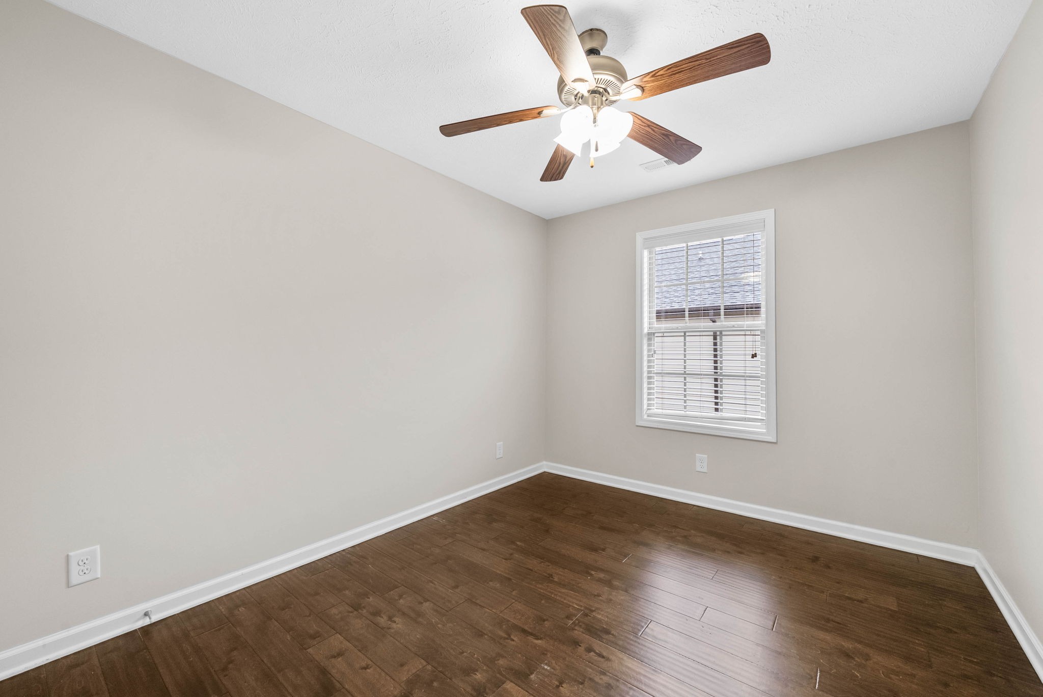 133 Melbourne Drive, Unit E Clarksville, TN 37043 - Photo 13 of 16 an empty room with wooden floor ceiling fan and windows