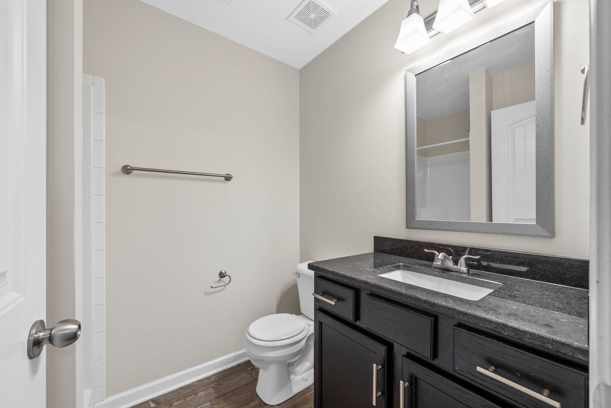 133 Melbourne Drive, Unit E Clarksville, TN 37043 - Photo 15 of 16 a bathroom with a granite countertop sink toilet and mirror