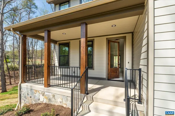 a en suite bathroom with a granite countertop sink a mirror and a bathtub