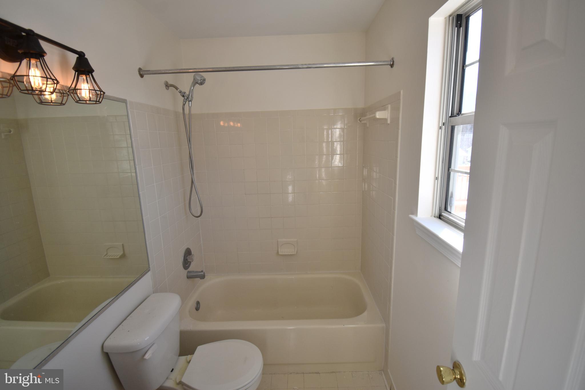 7707 Klovstad Drive Fort Washington, MD 20744 - Photo 10 of 15 a bathroom with a shower a bathtub and a shower
