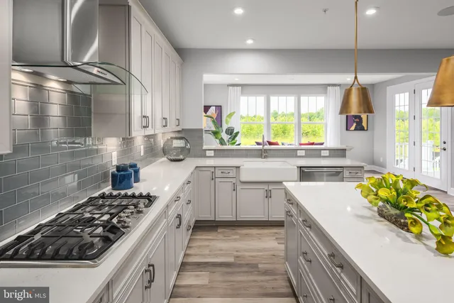 a kitchen with kitchen island a stove a sink and a refrigerator