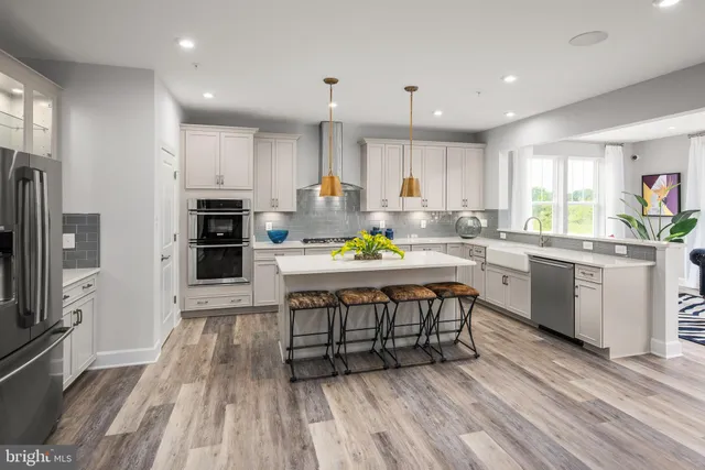 a kitchen with a sink appliances and cabinets