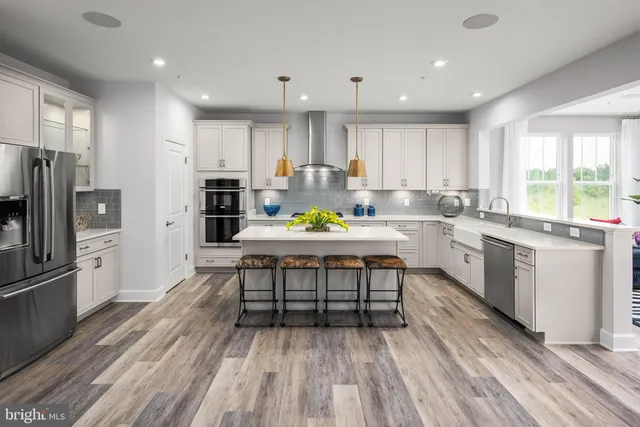 a kitchen with a sink appliances and cabinets