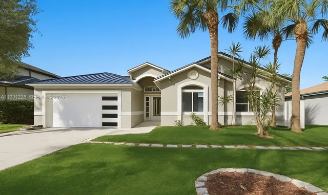 a front view of a house with a garden