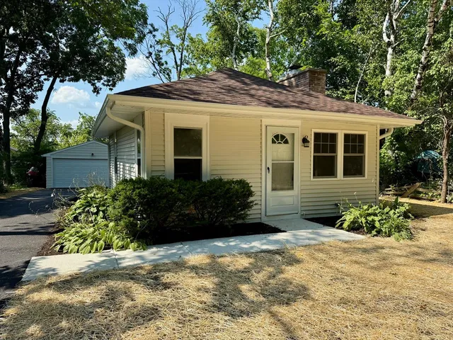 a view of a house with a yard and plants