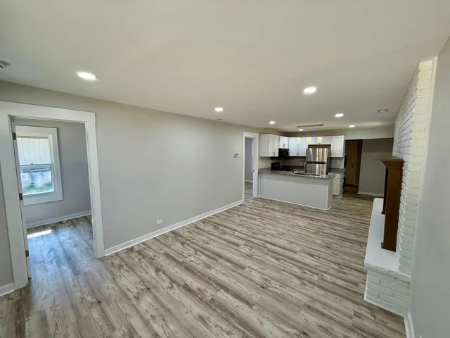 a view of kitchen with kitchen island sink and refrigerator
