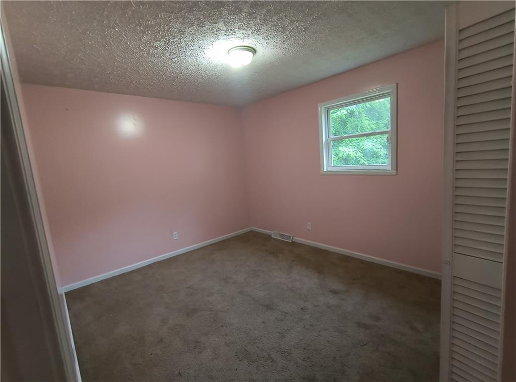 89 Murray Springs Road Chatsworth, GA 30705 - Photo 12 of 14 an empty room with a empty space and windows