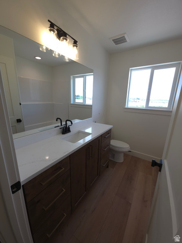1267 West 2350 South Perry, UT 84302 - Photo 16 of 20 Bathroom featuring a broad vanity with wood-finish cabinetry, a white countertop, and an integrated rectangular sink