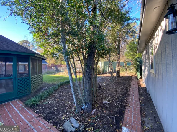 a bedroom with a bed and a lamp