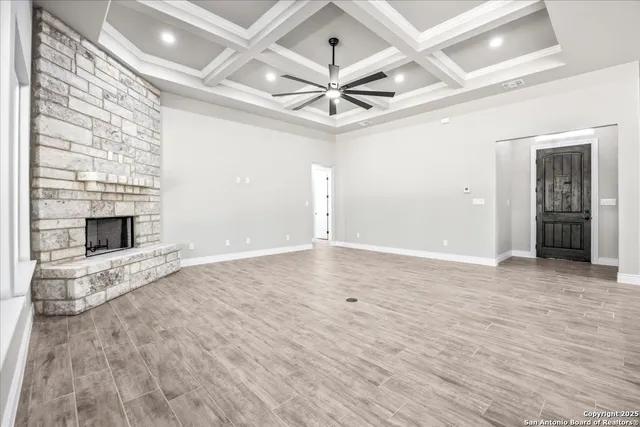 wooden floor in an empty room with a fireplace