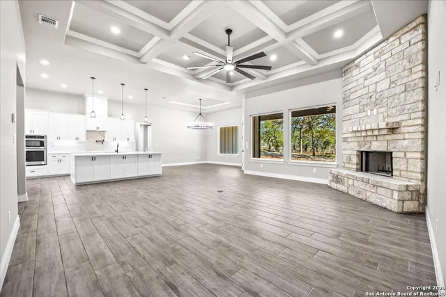a view of kitchen and hall with wooden floor