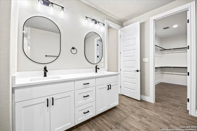 a bathroom with a double vanity sink and a mirror