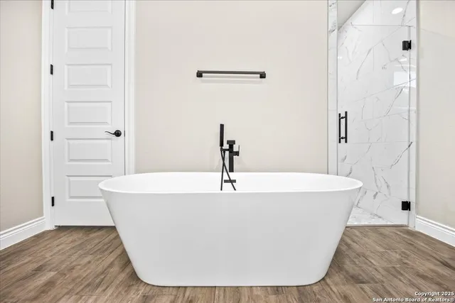 a white bath tub sitting in a bathroom