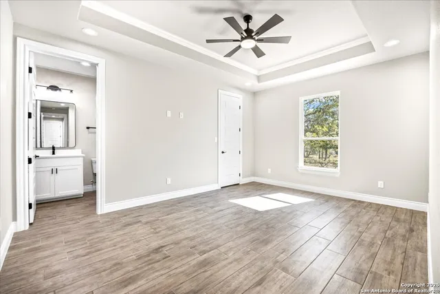 a view of a big room with wooden floor and a bathroom