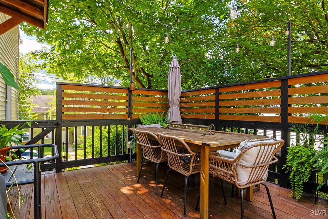 389 West Nesquehoning Street Easton, PA 18042 - Photo 40 of 44 a view of a patio with table and chairs with wooden floor and fence