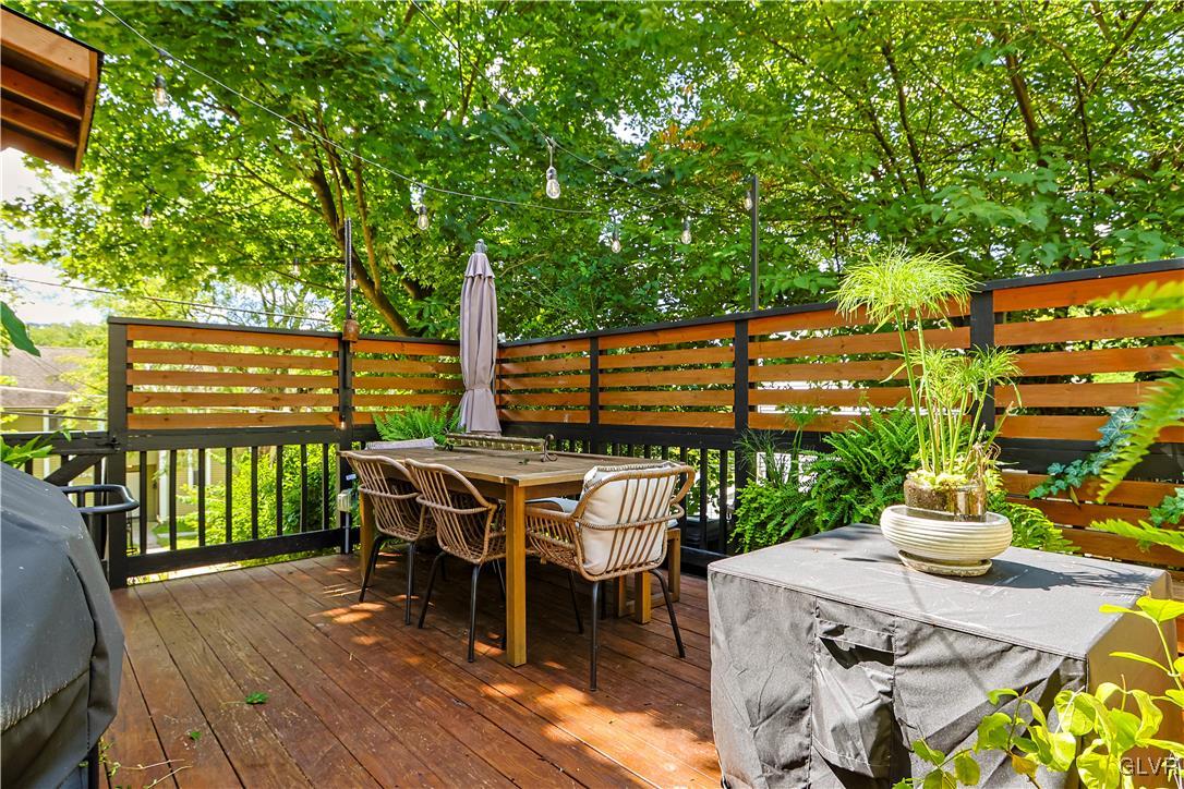 389 West Nesquehoning Street Easton, PA 18042 - Photo 4 of 44 a view of a patio with table and chairs and wooden floor and fence