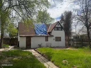 a front view of house with a garden