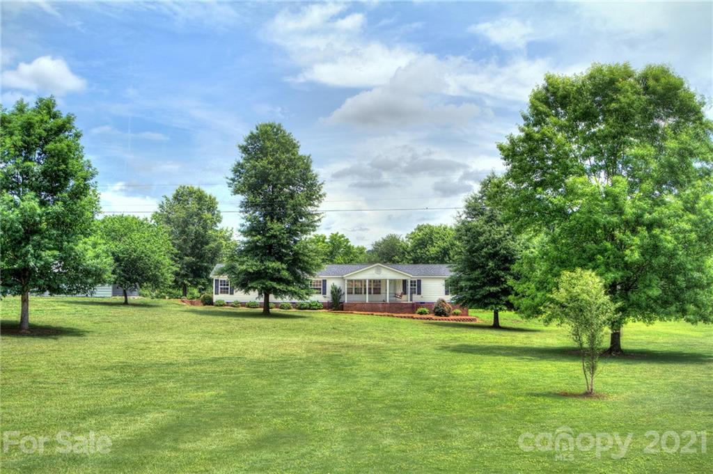 7918 Morgan Mill Road Monroe, NC 28110 - Photo 1 of 37 a view of a house with a big yard