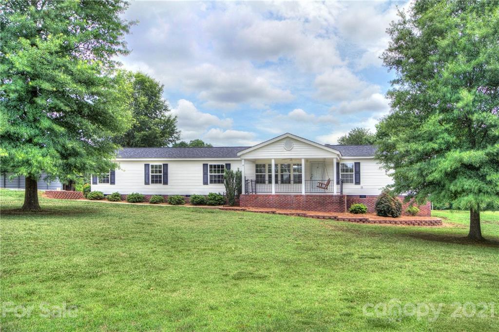7918 Morgan Mill Road Monroe, NC 28110 - Photo 2 of 37 a front view of a house with a yard and trees