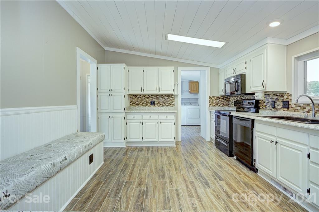 7918 Morgan Mill Road Monroe, NC 28110 - Photo 12 of 37 a large kitchen with a stove and sink
